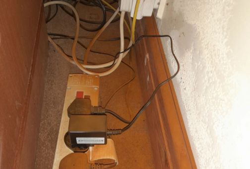 Dry rot spores visible on skirting boards and carpet.